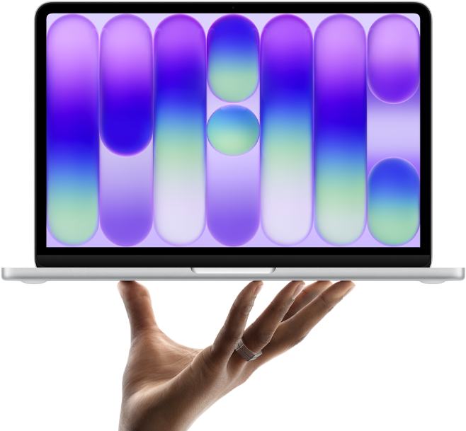 MacBook Neo couleur argent, en équilibre sur le bout des doigts d’une main ouverte, l’écran affichant un motif abstrait coloré